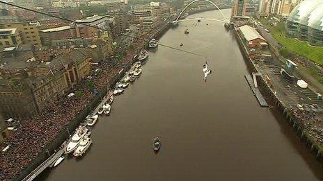 Bear Grylls travels with the Olympic flame by zip wire