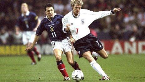 John Collins and David Beckham battle for the ball in 1999