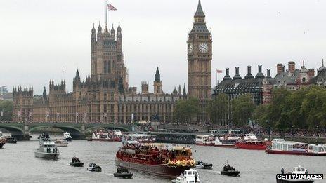 Houses of Parliament seen behind the Jubilee Pageant on the Thames