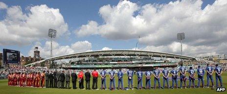 England and West Indies players hold a minute's silence before their match on Tuesday