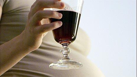 Pregnant woman with glass of wine