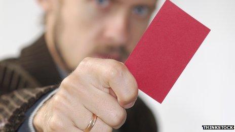 Man showing a red card to a colleague