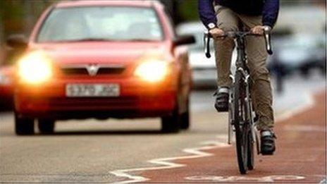 Bicycle and car on road