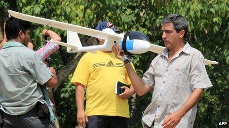 Handout photograph from the World Wildlife Fund (WWF) Nepal showing conservationists from the WWF testing an automated drone aircraft in Chitwan National Park on June 12, 2012.