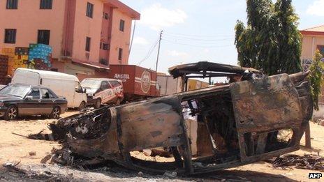A photo taken on 18 June 2012 shows a car vandalised in revenge attacks after a church was bombed in Kaduna on Sunday