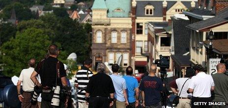 People try to get a glimpse of the jury arriving for the Jerry Sandusky child sex abuse trial at the court on 22 June 2012 in Bellefonte, Pennsylvania