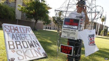 Jorge Mendez protests the Arizona immigration law outside the state capitol in Phoenix, Arizona 22 June 2012