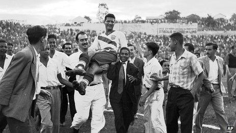 US goalscorer Joe Gaetjens is carried off by cheering fans after his team beat England 1-0 in a World Cup match in Belo Horizonte