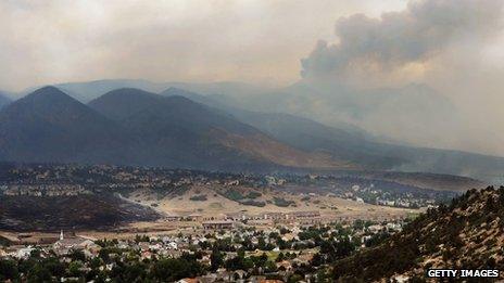 Smoke from the Waldo Canyon fire drapes the foothills on 27 June 2012 in Colorado Springs, Colorado.