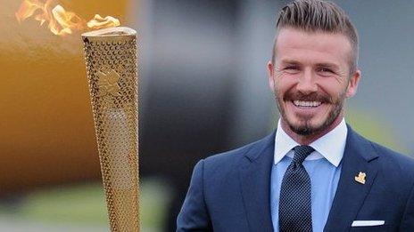 David Beckham holds the Olympic torch