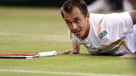 Lukas Rosol lies on the Wimbledon turf