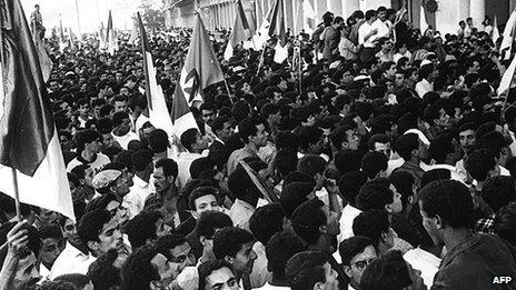 Crowds cheer Ben Khedda, premier of the provisional government of the newly independent Algeria