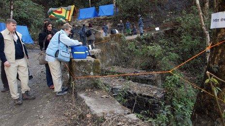 Finnish forensic experts Professors Helena Ranta (Foreground-L) and Pekka Saukko (R) prepare to carry out investigations in the Shivapuri jungle on the outskirts of Kathmandu on February 6, 2008 - where Maoist fighters killed by the army were suspected to be buried