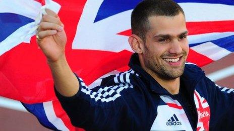 Robbie Grabarz holds the British flag aloft after winning high jump gold