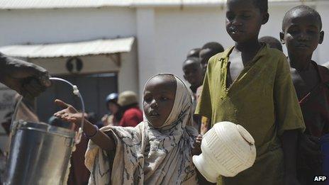 Displaced children queue for food rations in Somalia's capital, Mogadishu, in January 2012