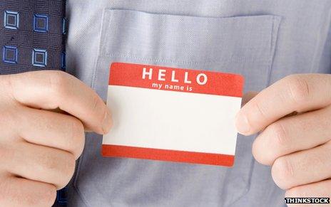 Man putting on "Hello - my name is" sticker