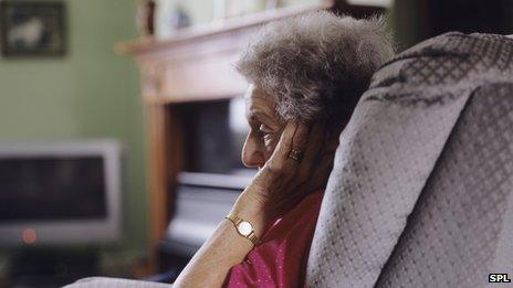 Elderly woman sitting alone