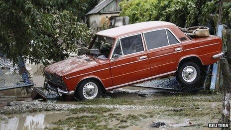 A stranded car is seen in a recently flooded street in the southern Russian town of Krymsk