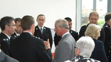 Prince Charles and Duchess of Cornwall speak to police and firefighters