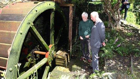 The Prince of Wales is shown the restored Felin Ganol Mill by miller Andrew Parry