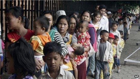 Cambodian villagers and their children outside hospital