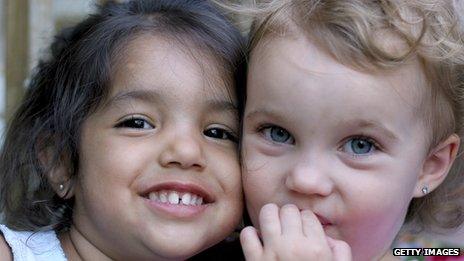 Two children wearing earrings