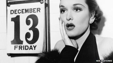 Young woman shocked at seeing Friday 13 on calendar