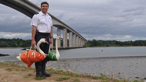 RSPCA inspector Jason Finch with two mute swans