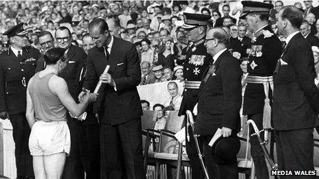 Ken Jones hands the baton containing the Queen's message to the Duke of Edinburgh at the opening ceremony of the British Empire and Commonwealth Games, Cardiff Arms Park, 1958. ONE USE ONLY AGREED WITH ROB NORMAN