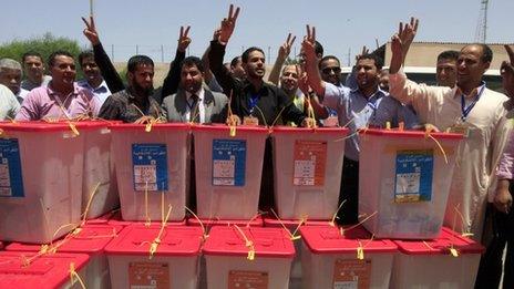 High Election Commission workers chant the national anthem behind ballot boxes which just arrived from the region of Kufra, at the High Election Commission Centre in Tripoli - 12 July 2012