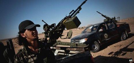 A Libyan militiaman stands at a check point near the border of Bani Walid in Misrata, Libya, Sunday, 15 July 2012