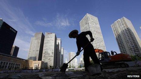 A labourer works at a construction site in Beijing"s central business district 12 July, 2012