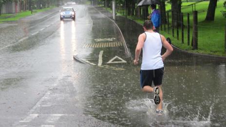 runner going through huge puddle