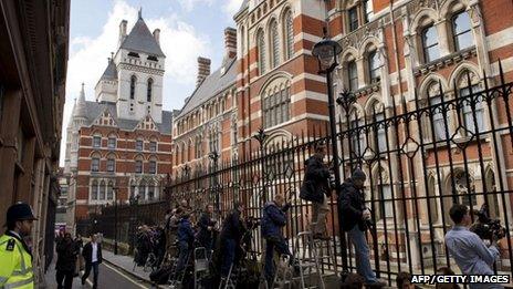 Journalists stand behind the railings waiting the arrival of British Prime Minister David Cameron to give evidence at the Leveson Inquiry into media ethics at the High Court in London on June 14