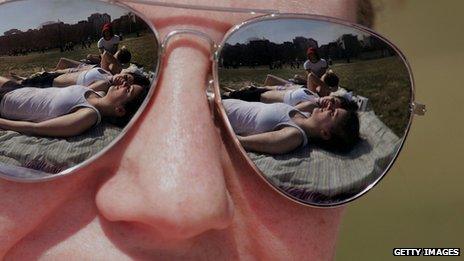 sunbathers reflected in sunglasses