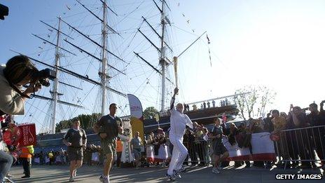 Around the world sailor Sir Robin Knox-Johnston carries the flame at the Cutty Sark