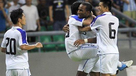 Didier Drogba is congratulated after setting up a goal on his Chinese League debut