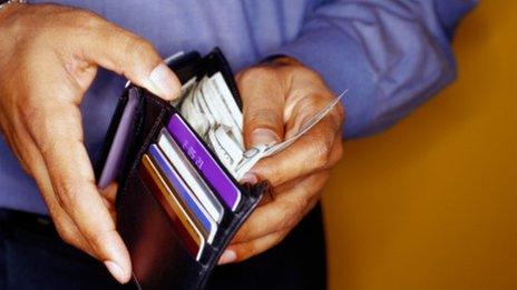 Man getting money out of his wallet