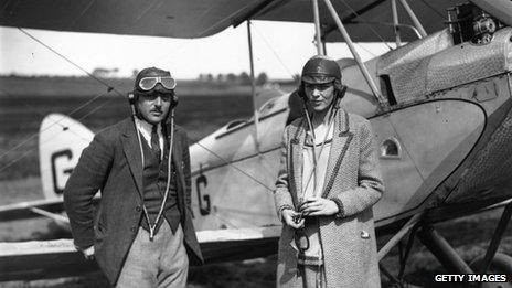 Amelia Earhart and an unidentified man stand in front of a plane in an undated file picture