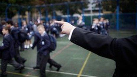 A teacher pointing at pupils