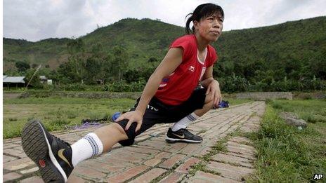 Indian boxer and five-time world champion Mary Kom warms up before she practices boxing at her residence in Langol Games village on the outskirts of Imphal