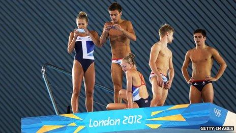 Team GB divers take photos from the diving board with their smartphones