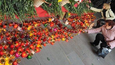 Women visit the memorial to those killed in bombing of the Minsk metro in 2011.