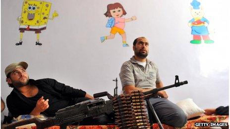 Fighters from the Syrian opposition rest at a former primary school in Aleppo