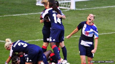 Britain's striker Kelly Smith (R) celebrates midfielder Jill Scott scoring the second goal against Cameroon