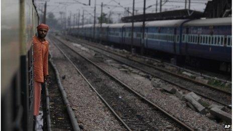 An Indian passenger looks out from the compartment of a stationary train following the power outage that struck in the early hours of Monday, July 30, 2012 at a train station in New Delhi, India