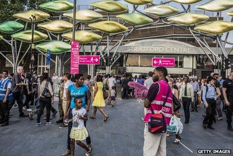 Volunteer directs spectators towards the Olympic Park