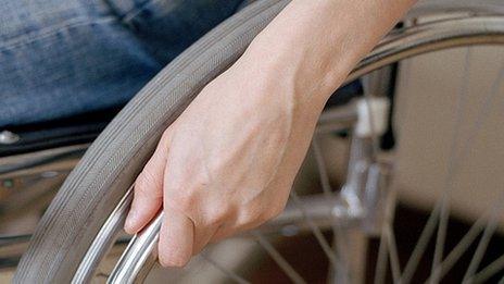 Man's hand on wheelchair