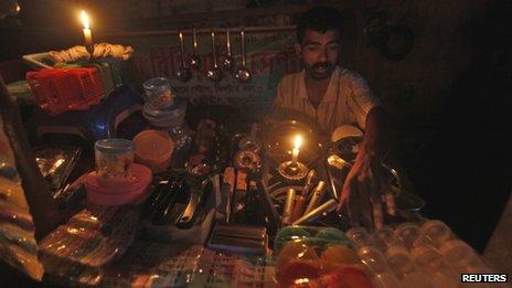 A shop owner during a power cut in Calcutta, India