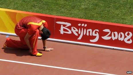 Liu Xiang clutching his ankle during the warm up prior to the first round of the men's 110m hurdles at the Bird's Nest during the 2008 Beijing Olympic Games, 18 Aug 2008